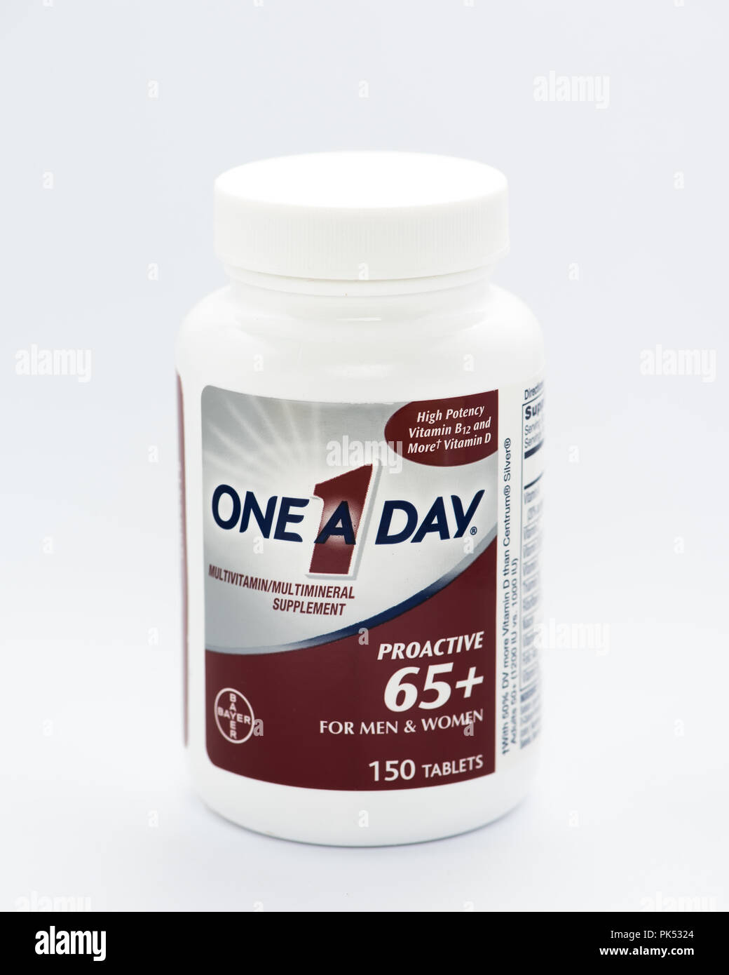 A white plastic bottle of One a Day multivitamin multimineral supplements for men and women over 65 years old. Stock Photo