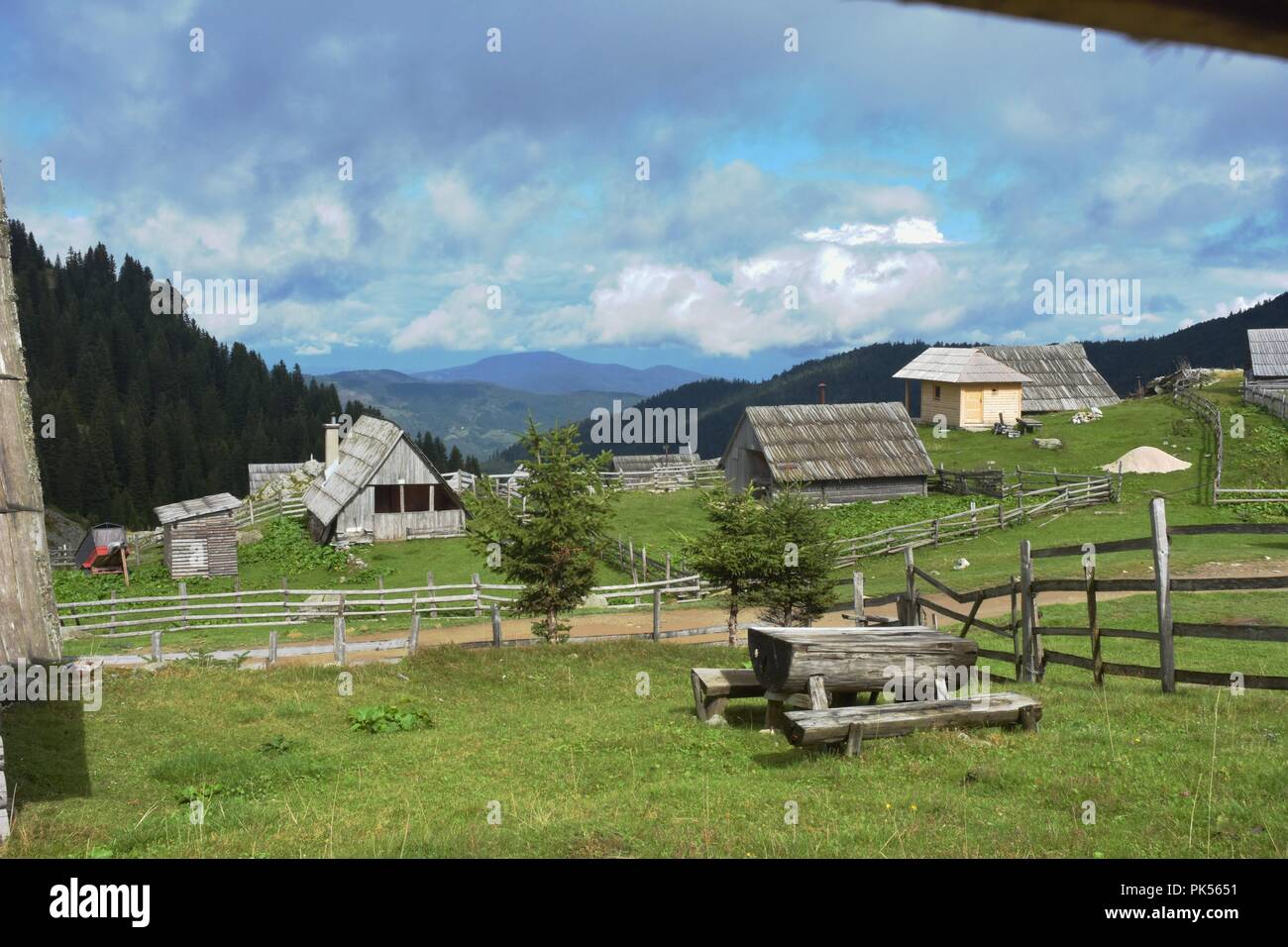 Beautiful image of serene rural shepherd cabins on the mountain valley Stock Photo