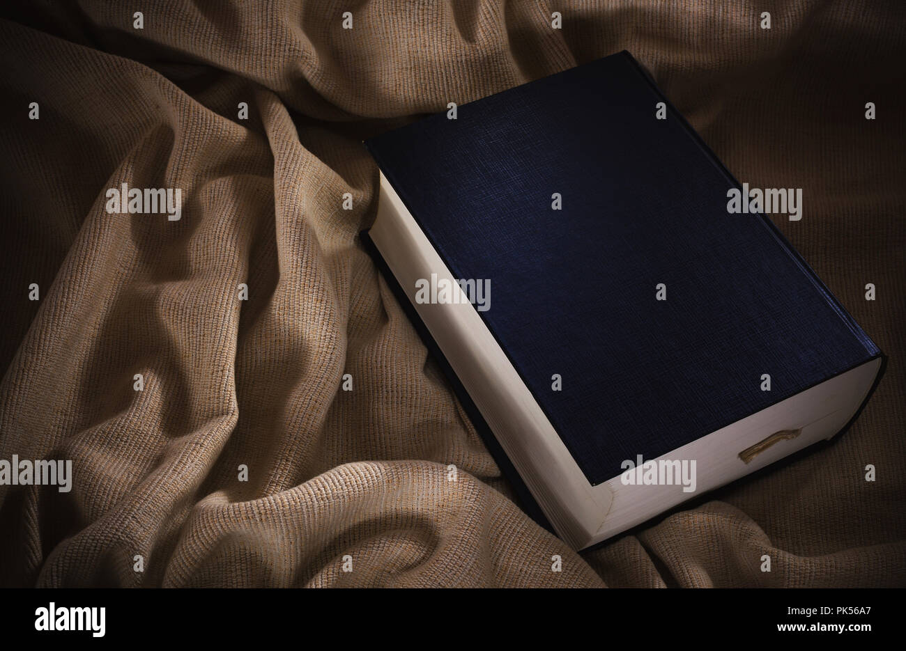 Closeup view of one big book on textile. Stock Photo