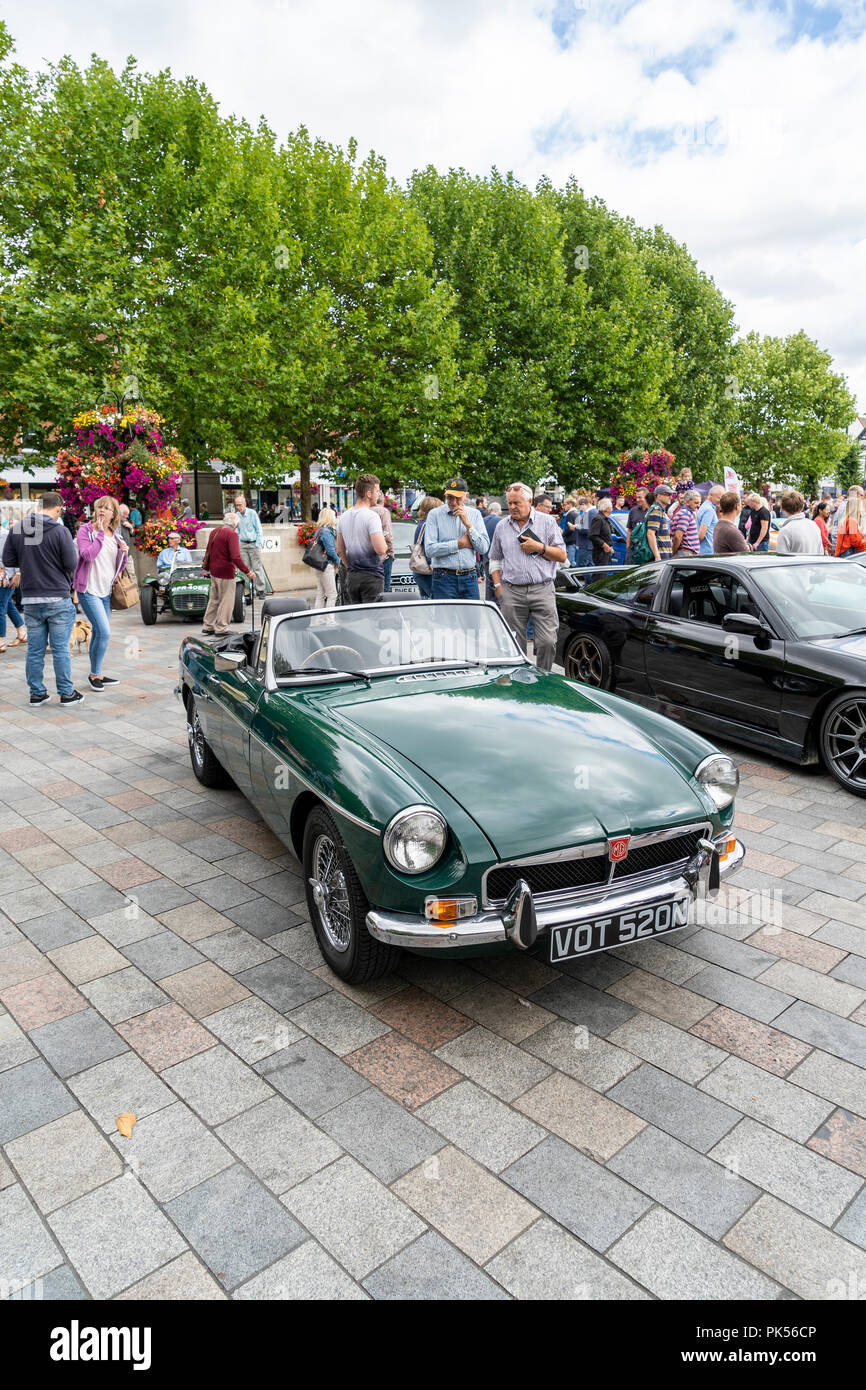 Green MGB roadster convertible and people at a car show in Salisbury UK