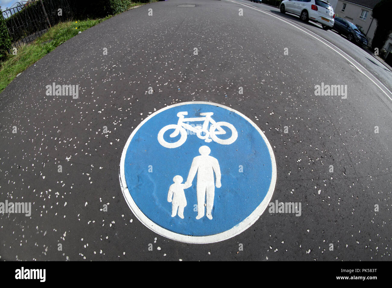 Shared use path sign bike child parent  blue sign in pavement Stock Photo