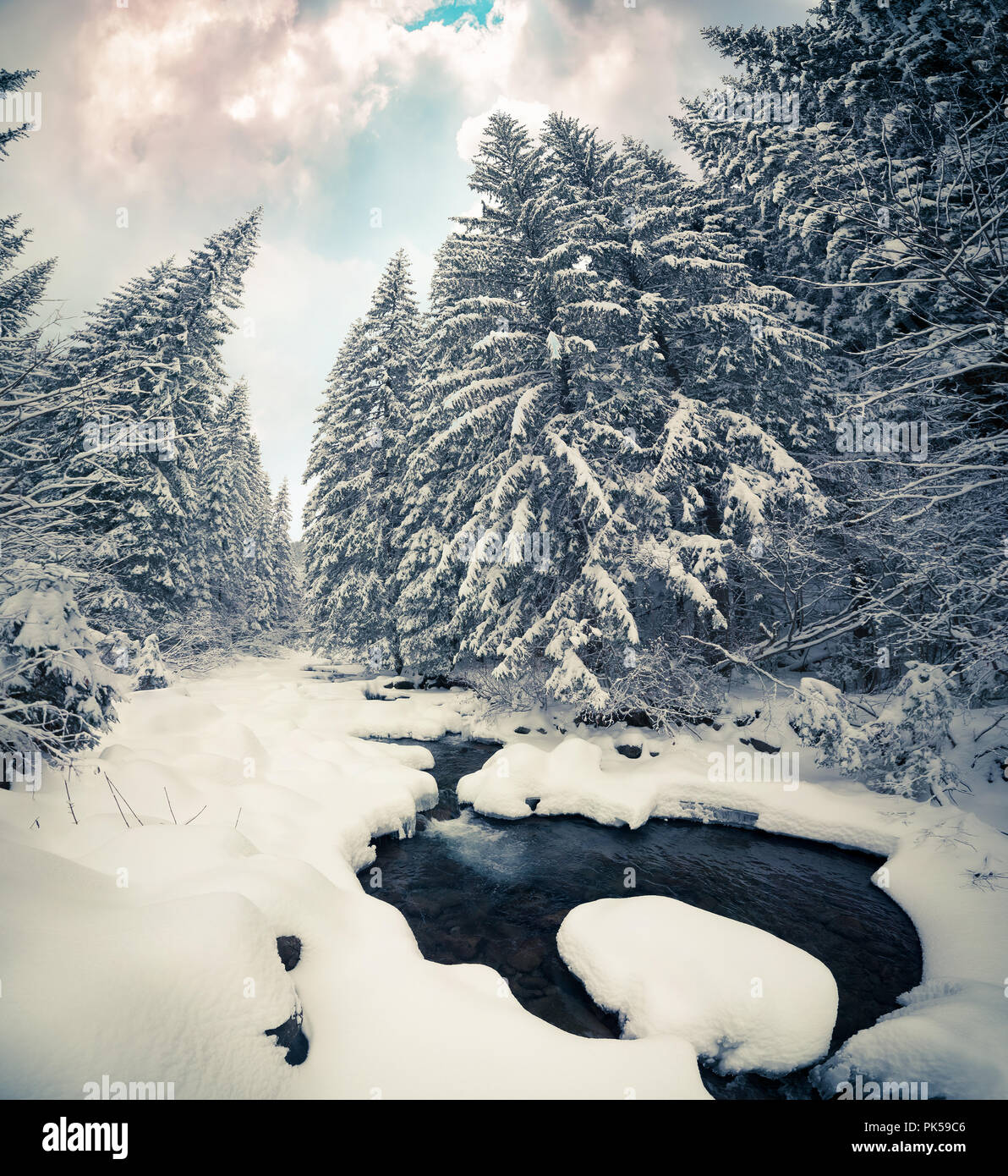 Dark river in the winter mountain forest. Retro style. Stock Photo