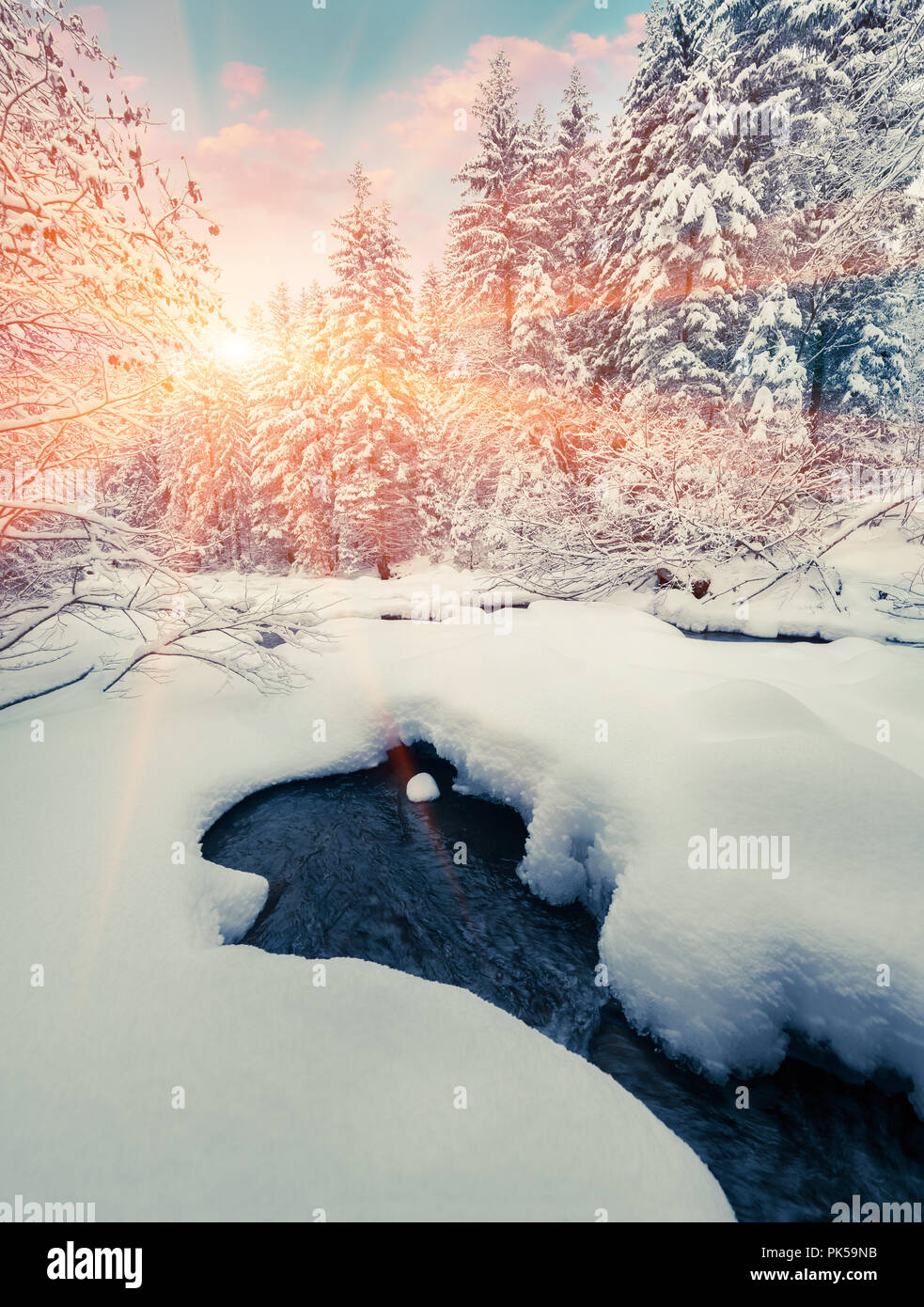 Colorful winter sunrise in the mountain forest with dark water river. Retro stile Stock Photo