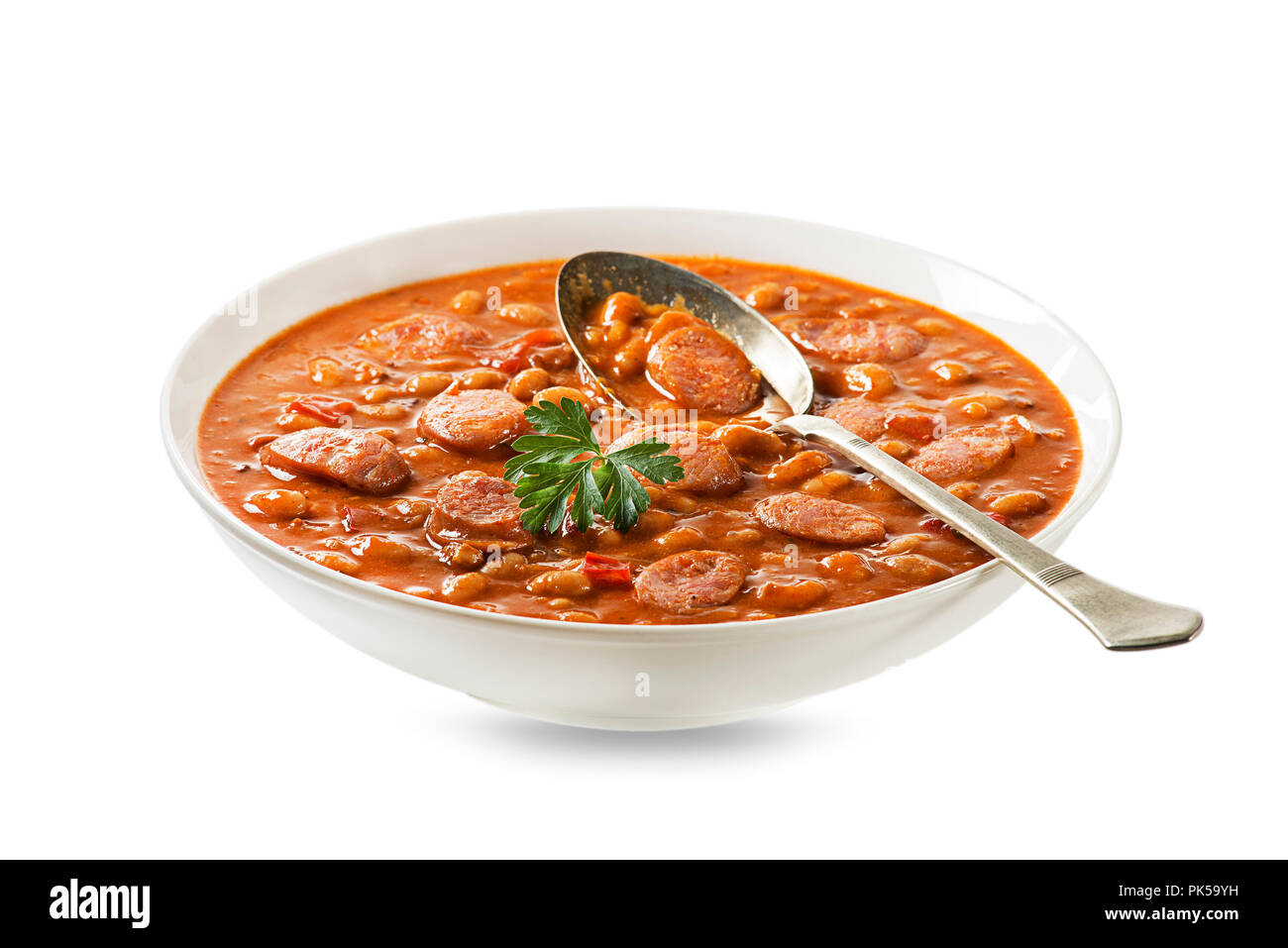 Baked beans stew with tomato sauce and sausage with herbs isolated on white Stock Photo