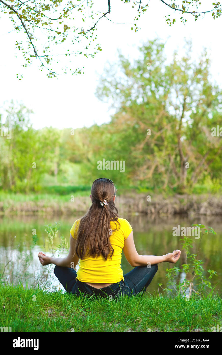 girl sitting on the bank of the river Stock Photo - Alamy