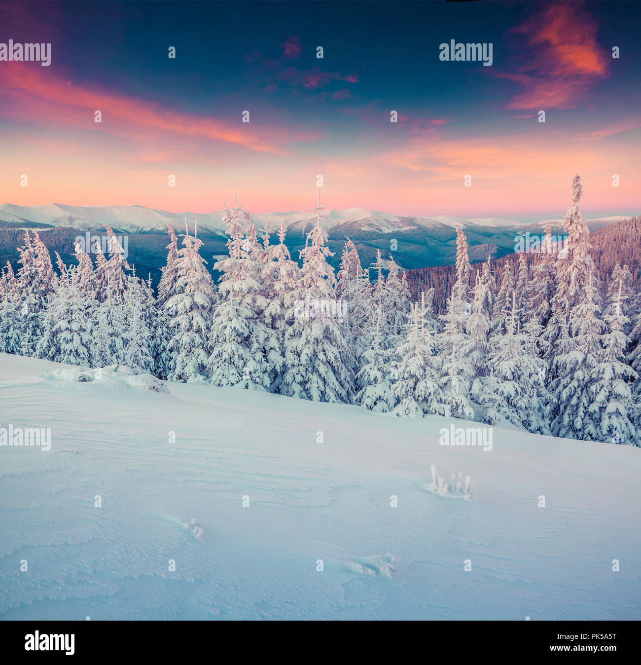 Colorful winter sunrise in the snowy mountains. Instagram toning. Stock Photo