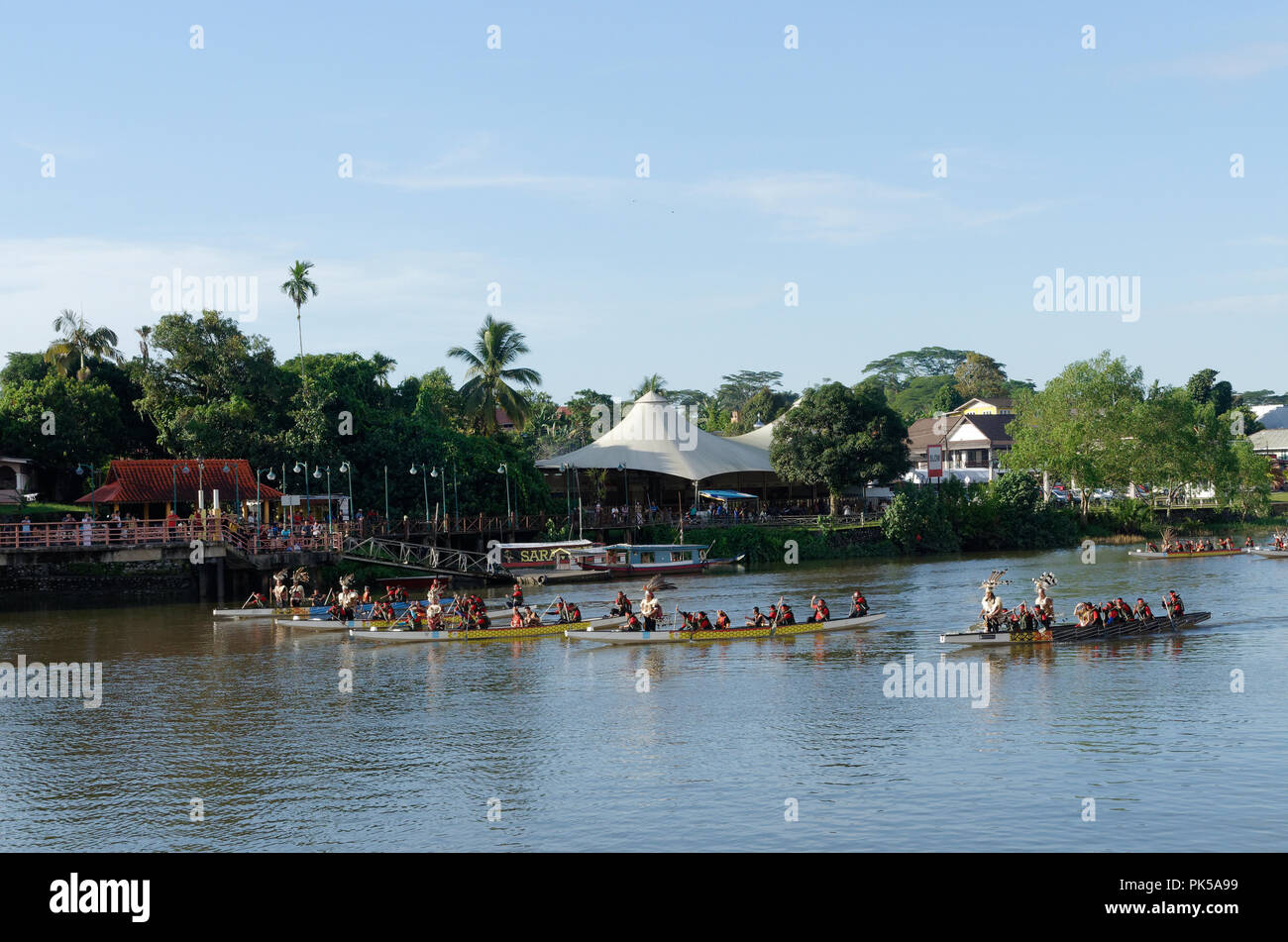 Kuching, Sarawak river, boats with natives in traditional dress form part of the Gawai day parade and celebration Stock Photo