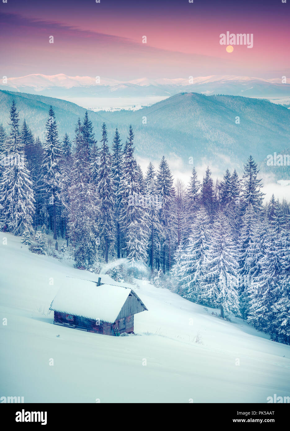 Forester's hut covered with snow in the mountains at sunrise.Instagram toning. Stock Photo