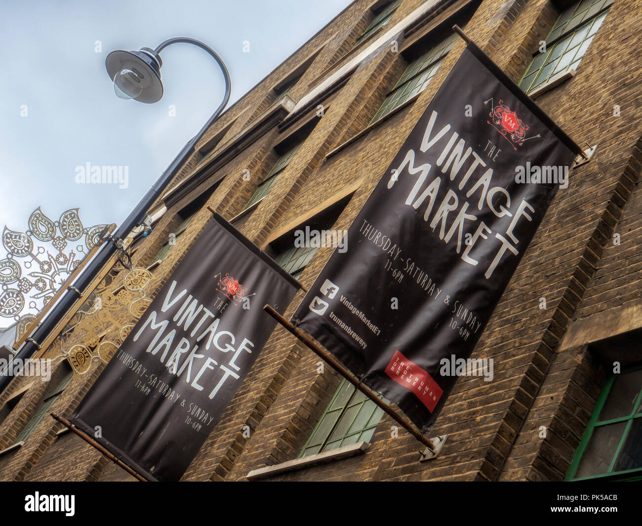 LONDON, UK - OCTOBER 11, 2015:  Signs for the Vintage Market (also known as Up market) in the Old Truman Brewery Building in Brick Lane Stock Photo