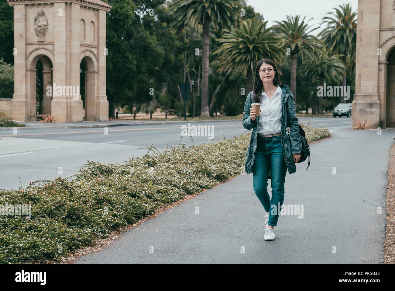 female student walking around the campus and ready for attending the class in a day. Stock Photo