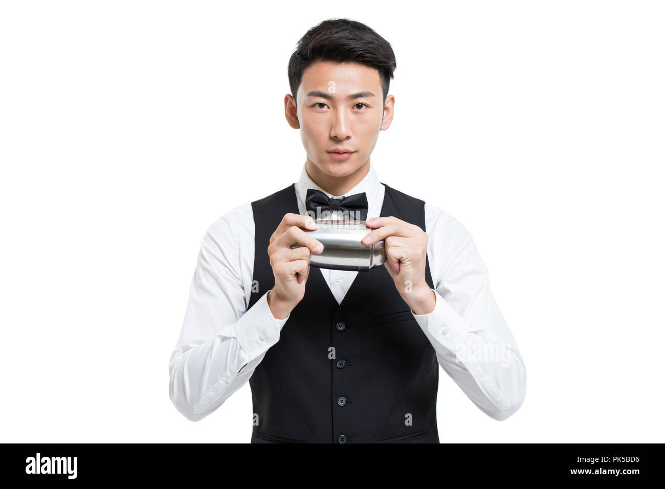Cheerful young bartender shaking drinks Stock Photo