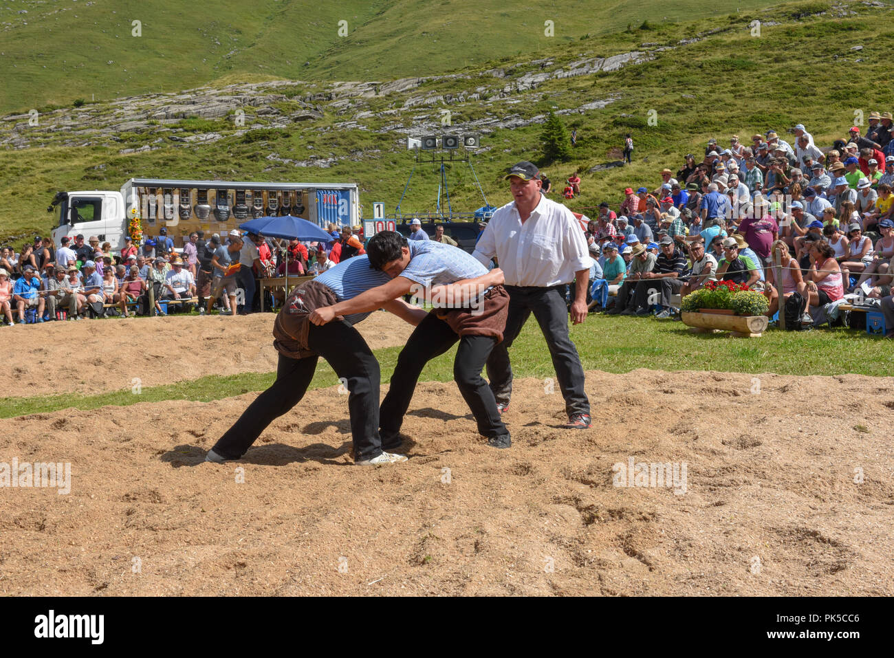 Engstlenalp, Switzerland - 4 August 2018: Two Swiss taking part in a traditional wrestling match (called 'Schwingen') at Engstlenalp on the Swiss alps Stock Photo
