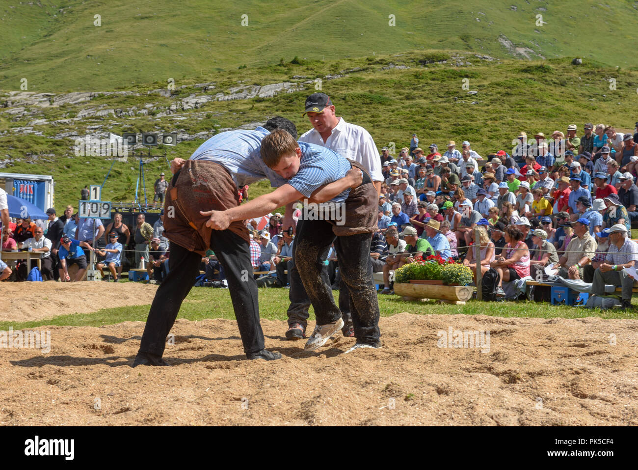 Engstlenalp, Switzerland - 4 August 2018: Two Swiss taking part in a traditional wrestling match (called 'Schwingen') at Engstlenalp on the Swiss alps Stock Photo
