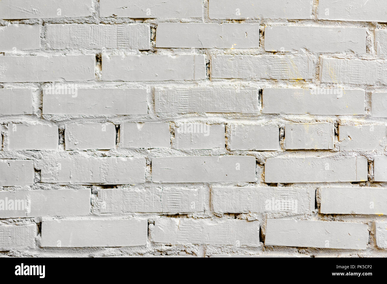 Painted white brick surface, urban background. Graphic grunge texture. For abstract backdrop, pattern, banner design Stock Photo