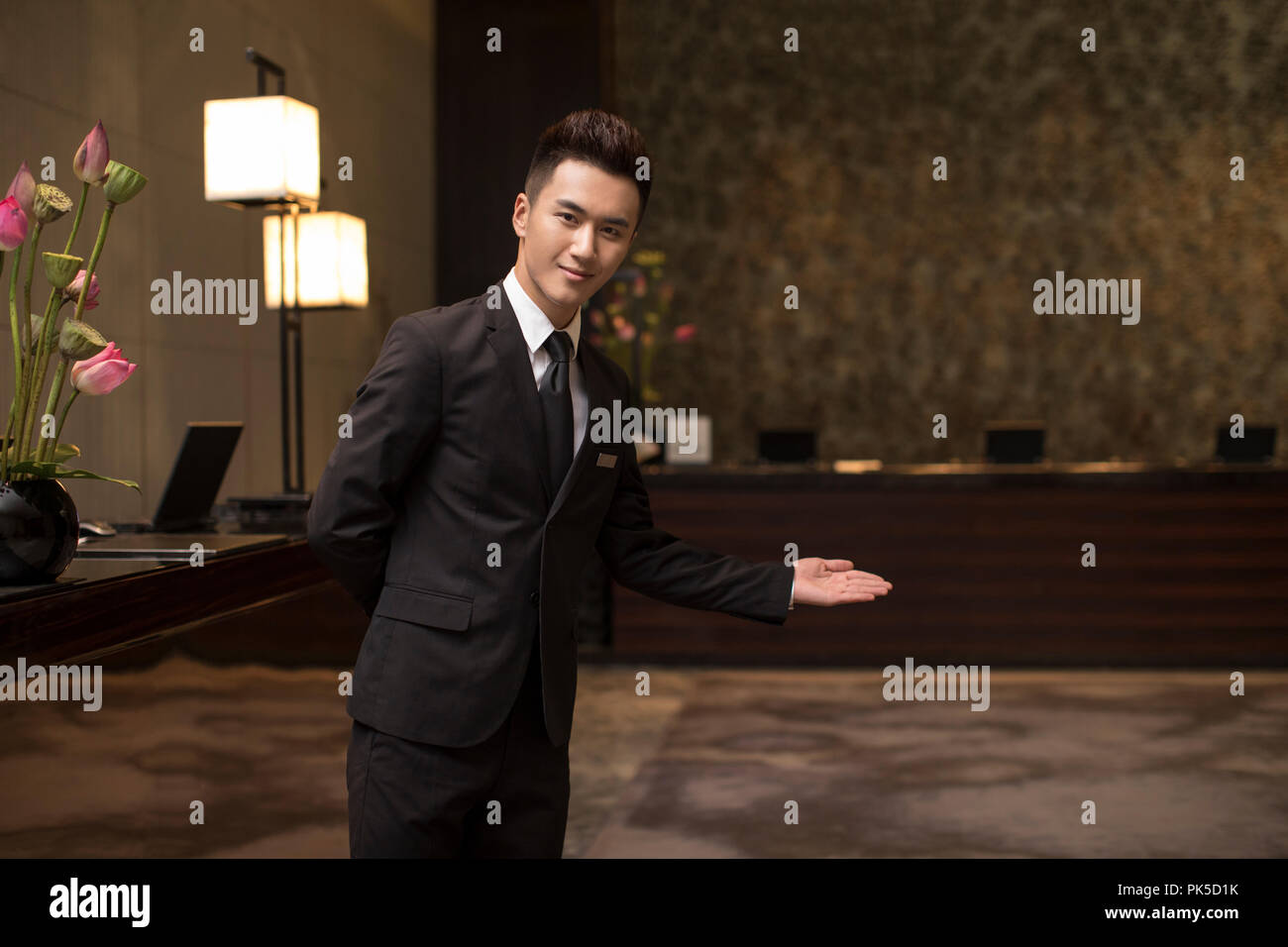 Confident hotel receptionist greeting Stock Photo Alamy