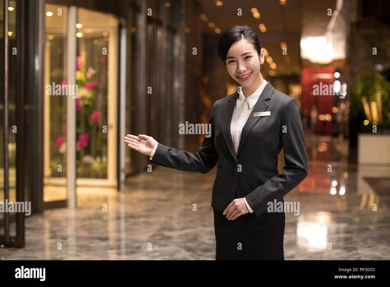 Confident hotel receptionist greeting Stock Photo Alamy