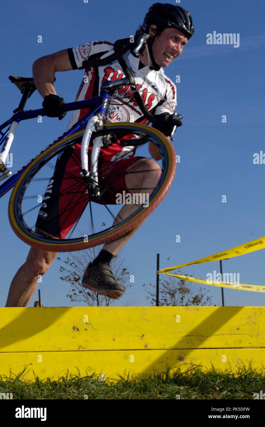 A rider clears the barrier at the cyclocross race at Ida Lee Park in Leesburg Virginia. Stock Photo