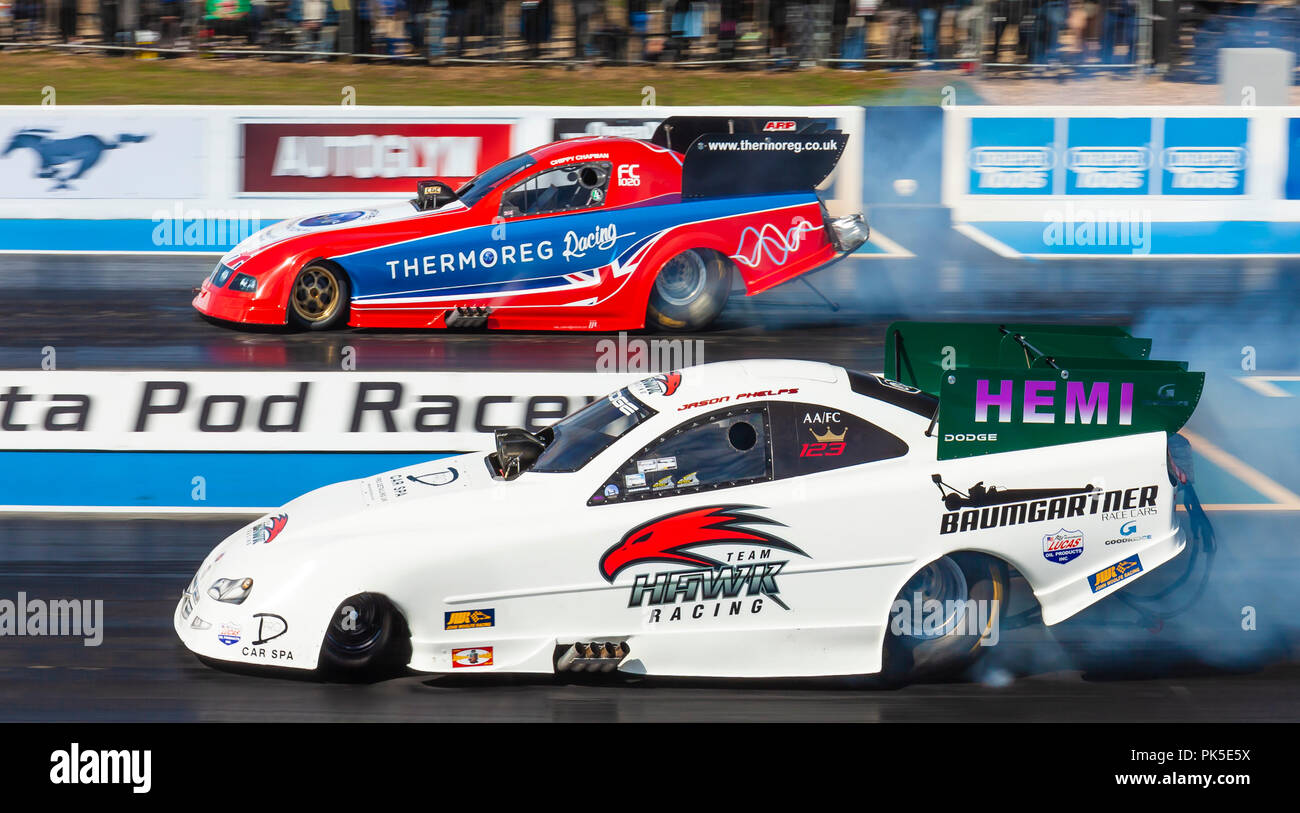 Top Fuel Funny car drag racing at Santa Pod Raceway. Jason Phelps in a Dodge Stratus nearside v Kevin Chapman in a Ford Mustang far side. Stock Photo