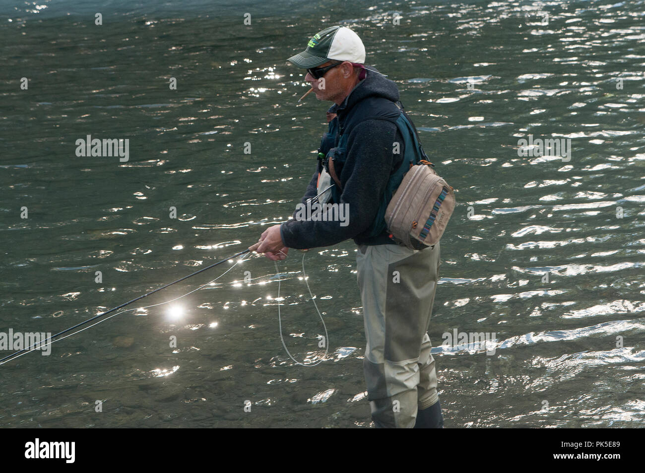 man wading and fishing Stock Photo