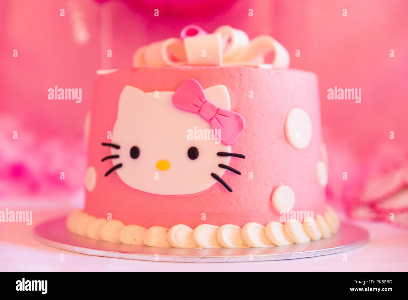 White and Pink Birthday Cake with Cat Head and Blurred Background ...