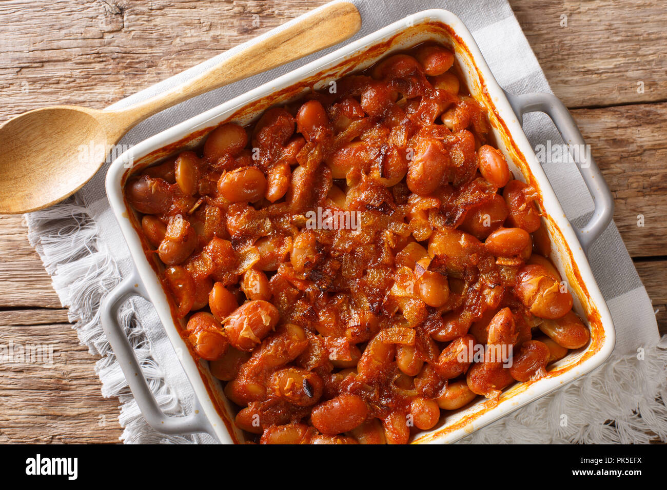 Serbian food: prebranac baked beans with onion close-up in baking dish on a table. horizontal top view from above Stock Photo