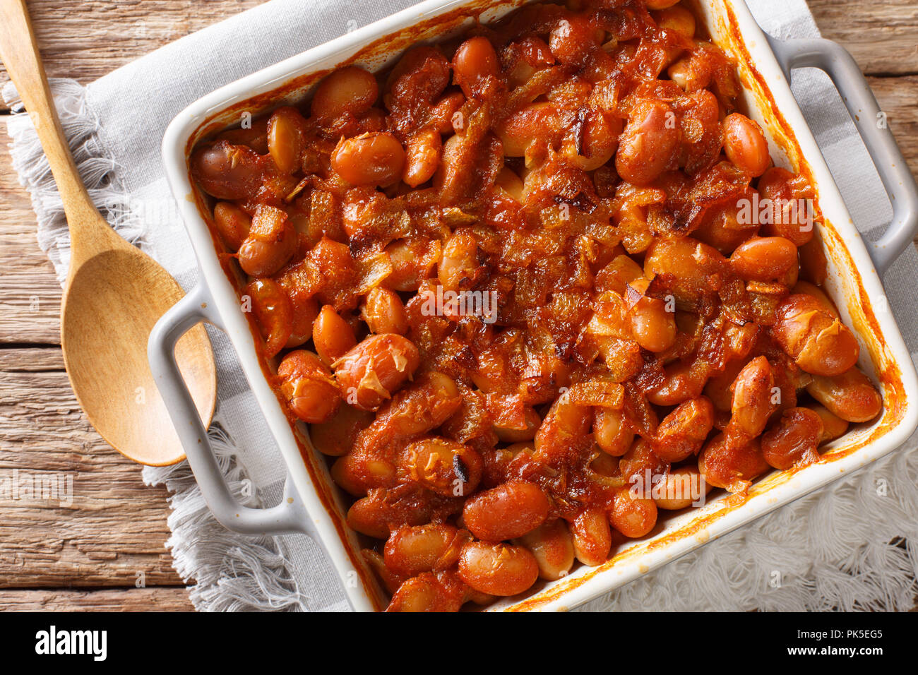 Delicious prebranac baked beans with onions close-up in a baking dish on a table. horizontal top view from above Stock Photo