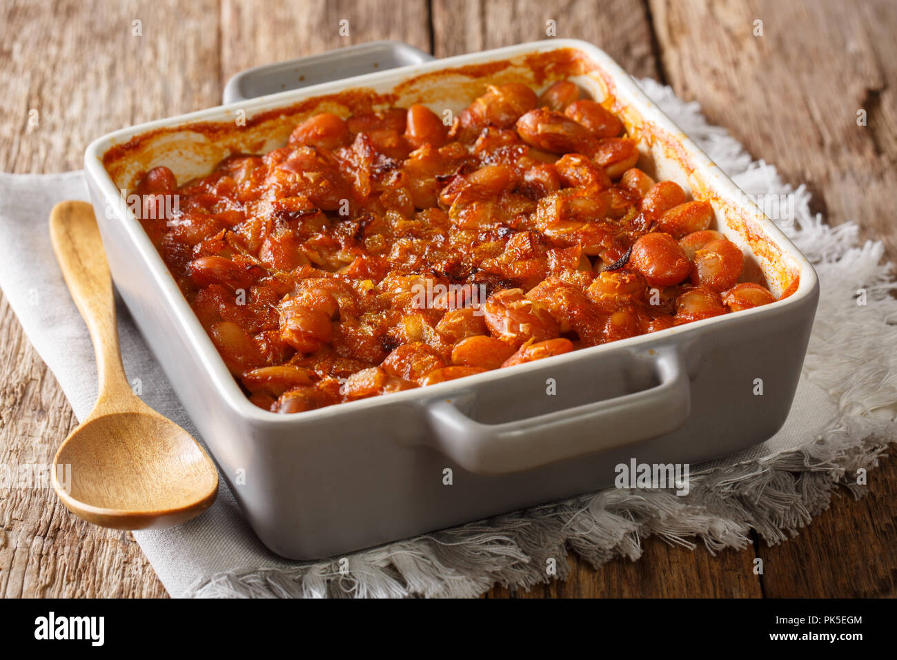 Vegetarian Balkan food prebranac baked beans with onions close-up in baking dish on a table. horizontal Stock Photo