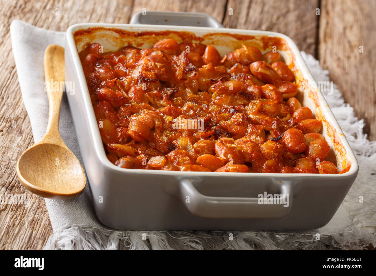 Traditional Balkan recipe prebranac baked beans with onion close up in baking dish on the table. horizontal Stock Photo