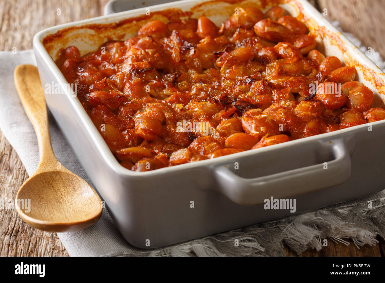 Delicious prebranac baked beans with onions close-up in a baking dish on a table. horizontal Stock Photo