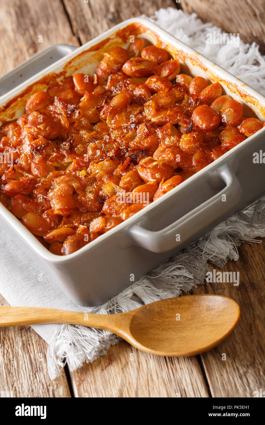 Balkan food: baked beans prebranac close-up in a baking dish on a table. vertical Stock Photo