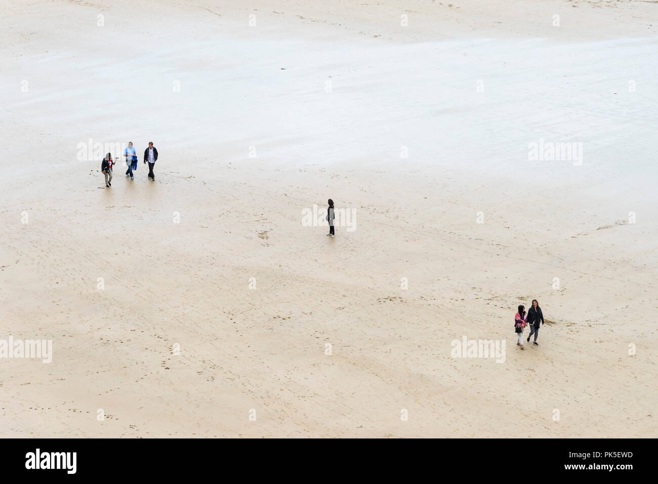 An overhead view of people walking across Great Western Beach in Newquay Cornwall. Stock Photo