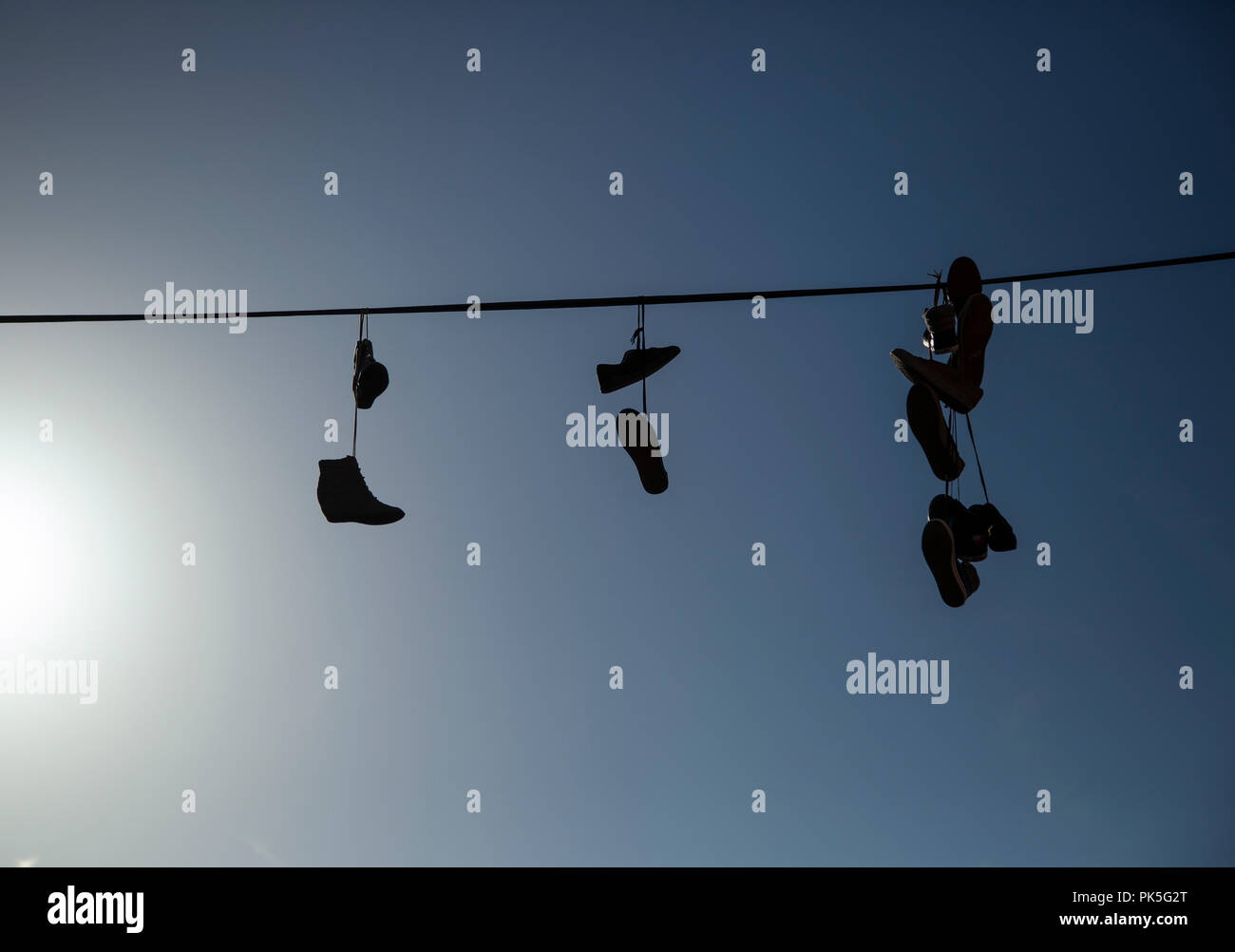 Shoes hanging from telephone line hires stock photography and images