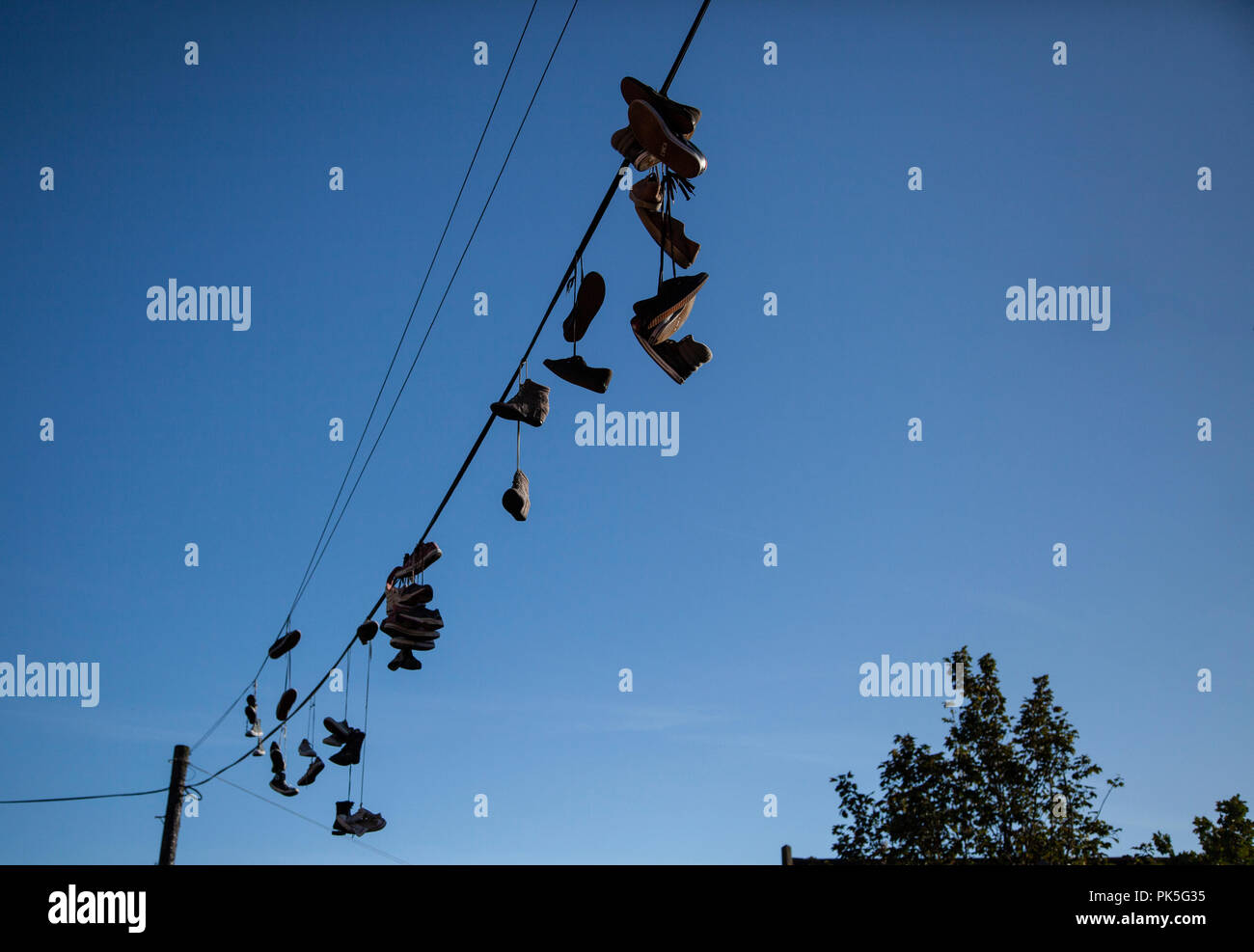 Sneakers hanging telephone wire hires stock photography and images Alamy