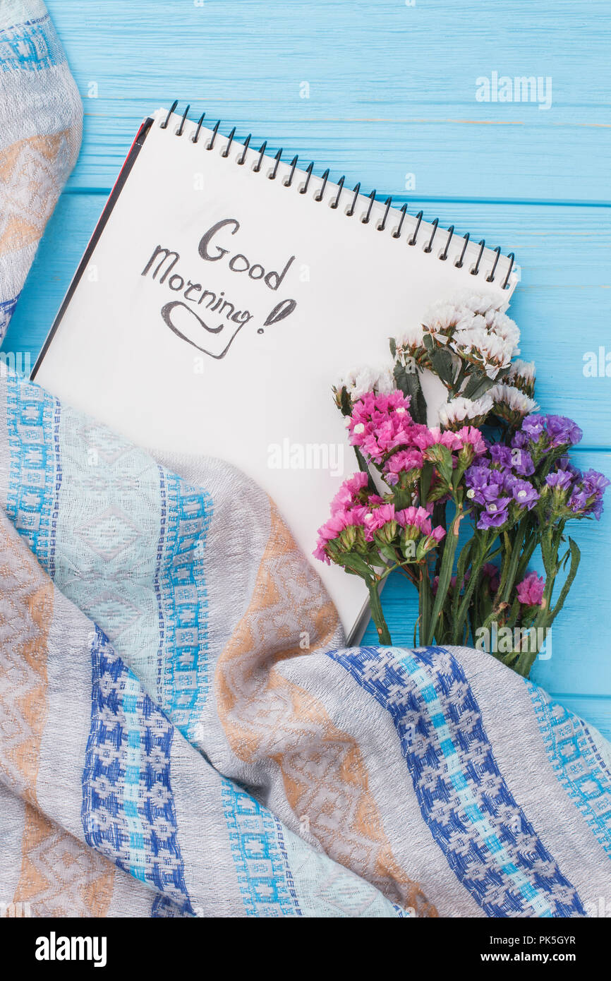 Wish Good Morning On Notebook Page And Statice Flowers Blue
