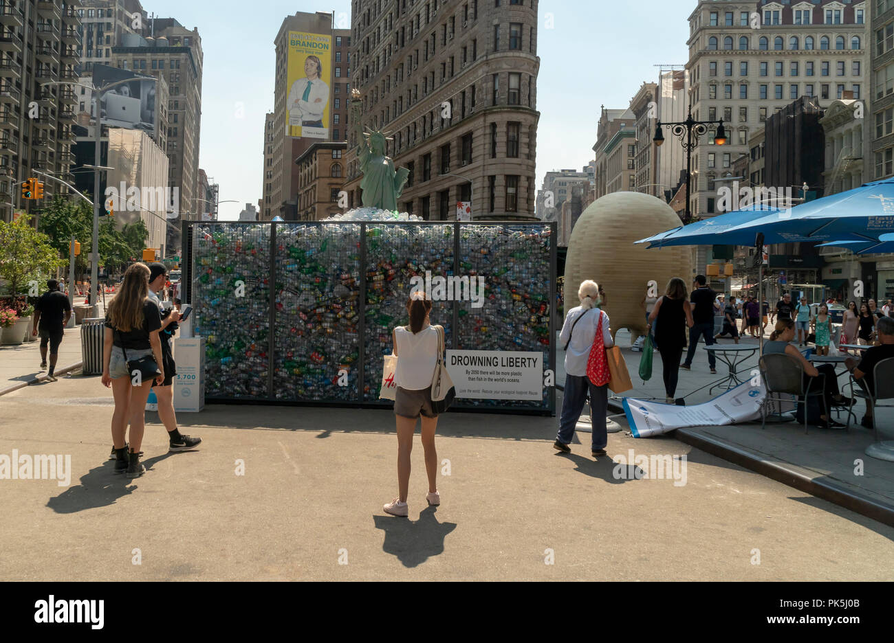 'Drowning Liberty' is unveiled at a SodaStream branding event in Flatiron Plaza in New York on Monday, September 3, 2018. The installation in partnership with the Oceanic Society consists of a 20 foot tall Lady Liberty trapped inside a cage filled with single-use containers. The event promotes the use of reusable containers, something that SodaStream does.  (Â© Richard B. Levine) Stock Photo