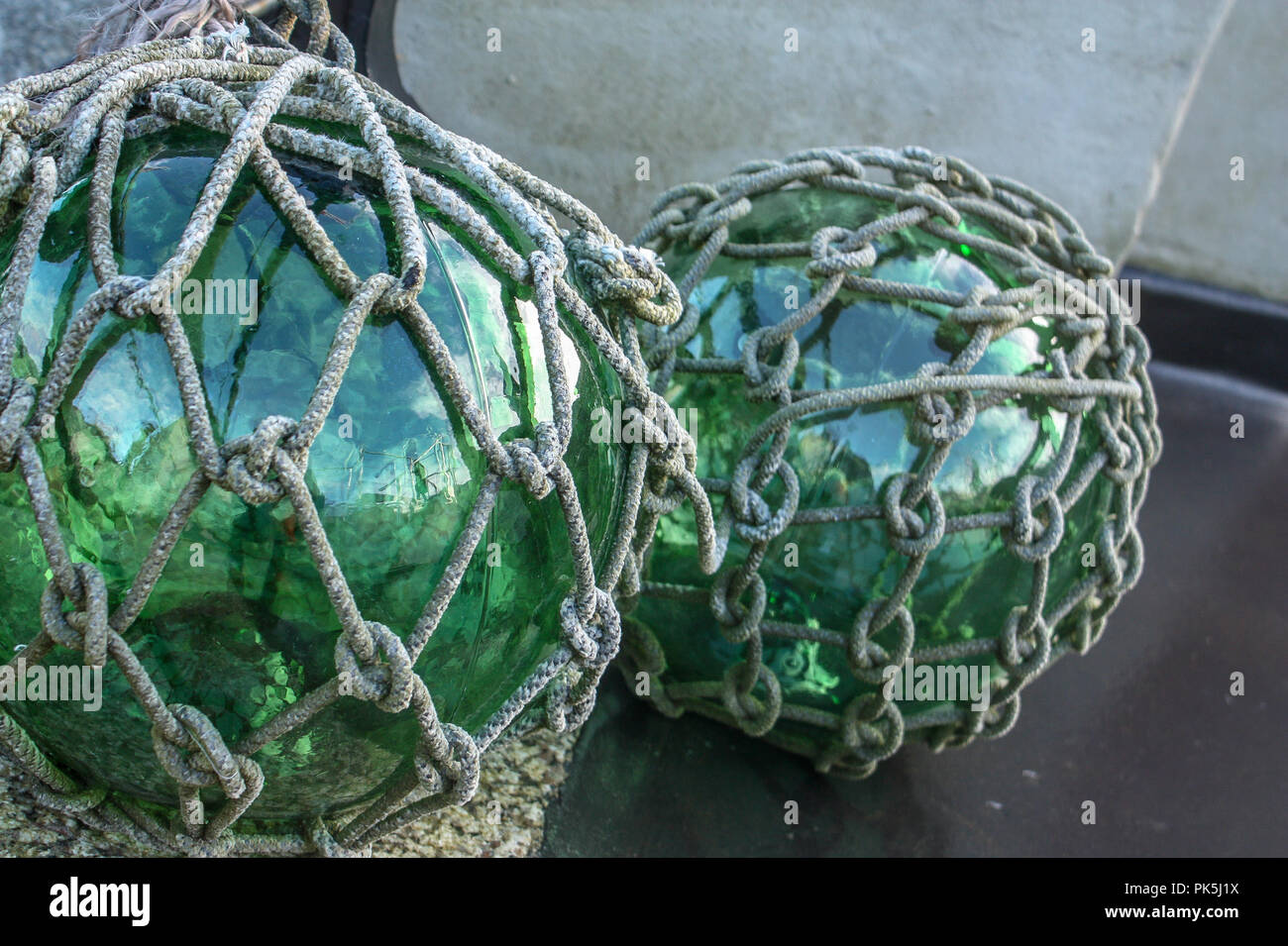 Vintage green glass fishing float balls knotted in jute rope Stock Photo -  Alamy