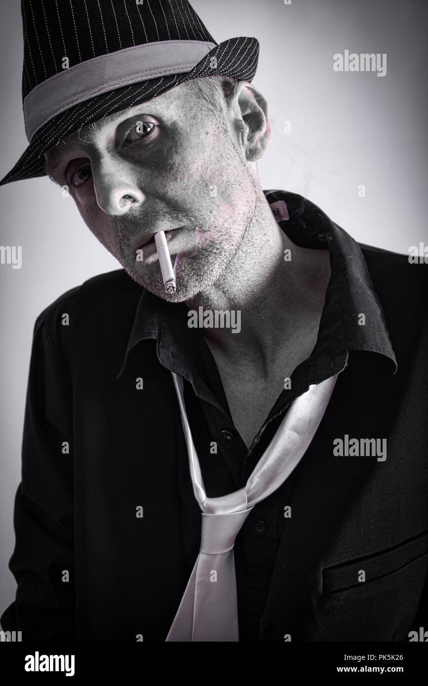 A mono image of a man smoking a cigarette Stock Photo