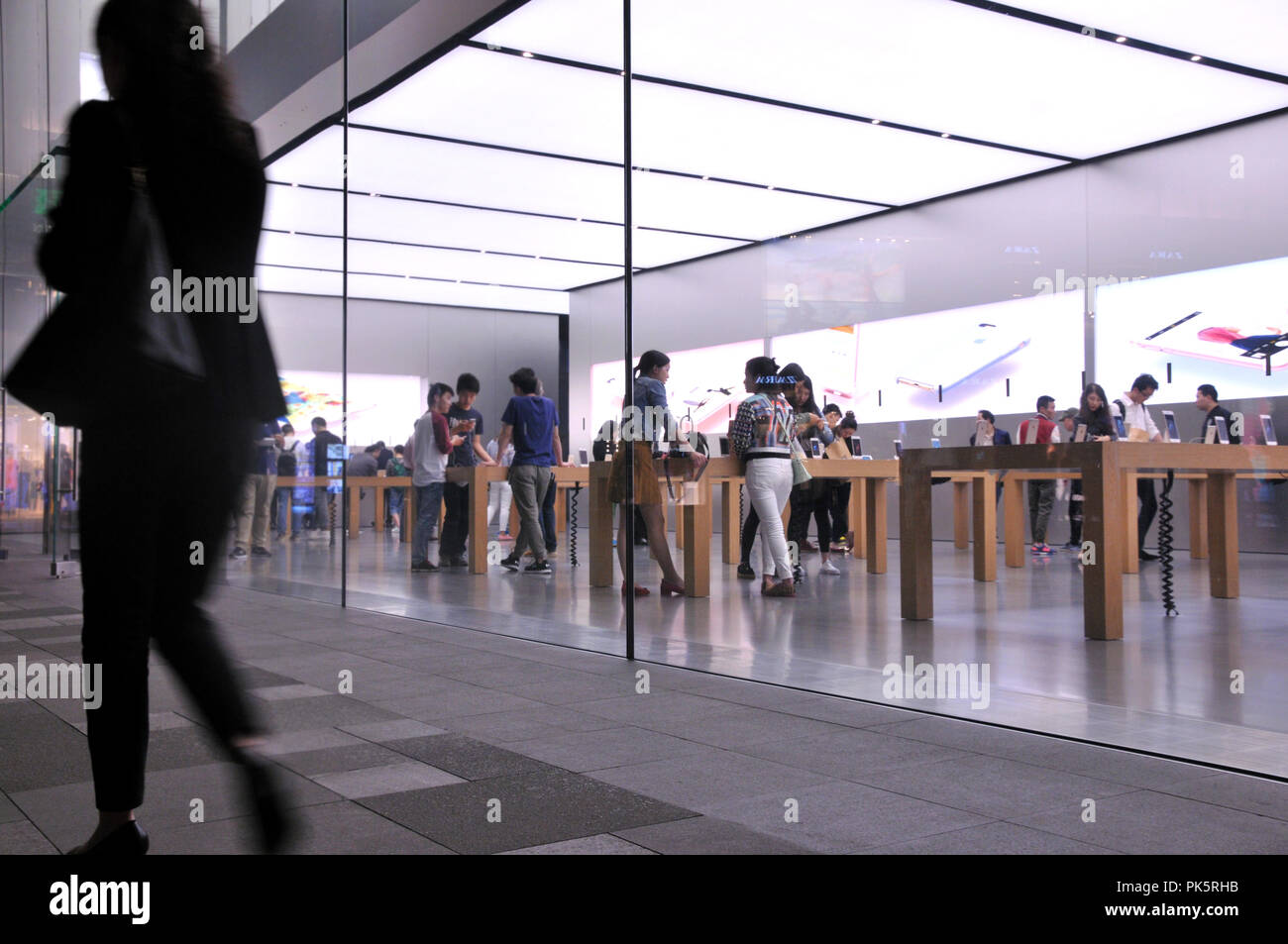 People at the Apple Store Chunxilu in Chengdu, China. Stock Photo