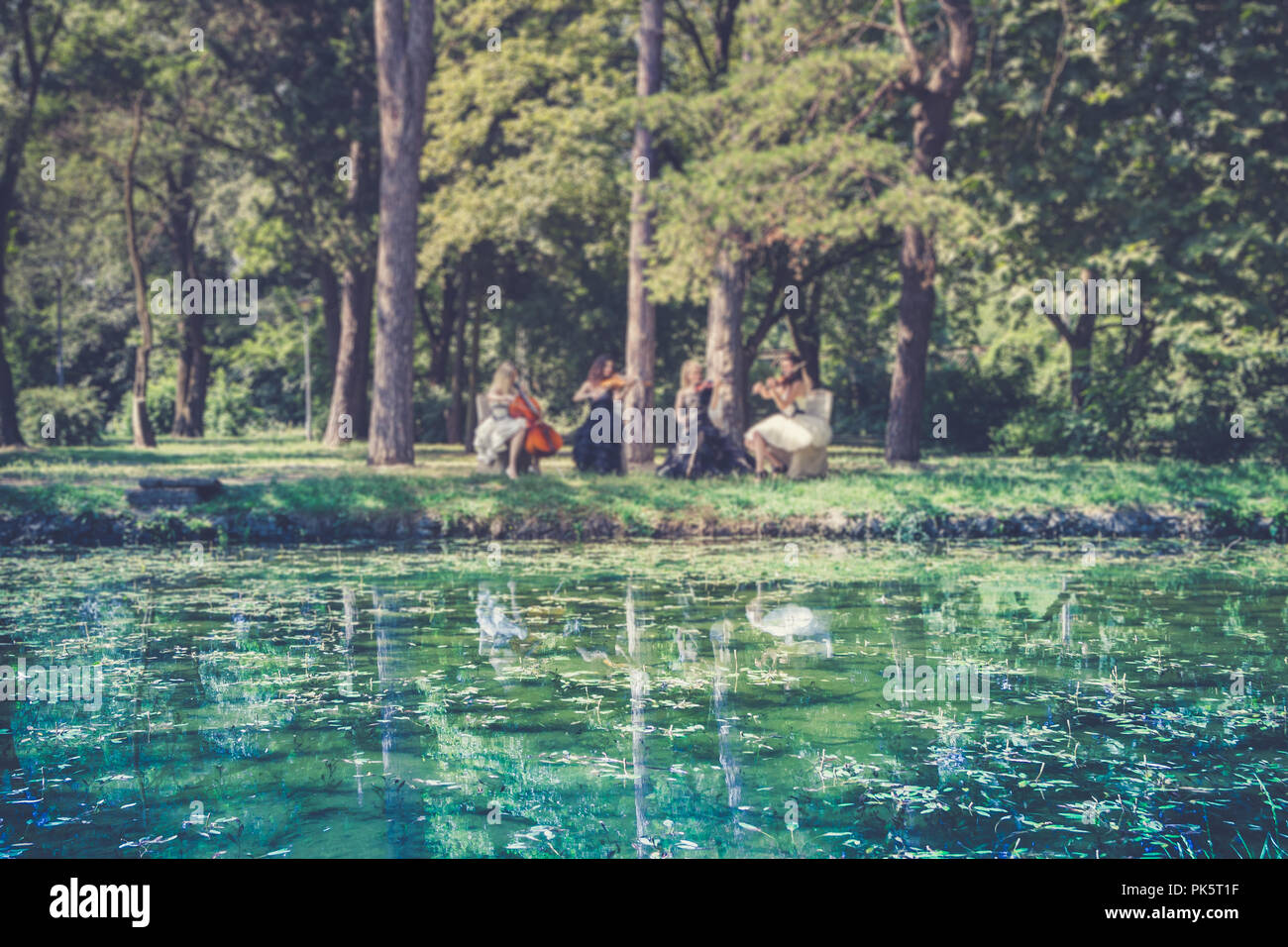 Music and nature concept. Female musical quartet with string ...