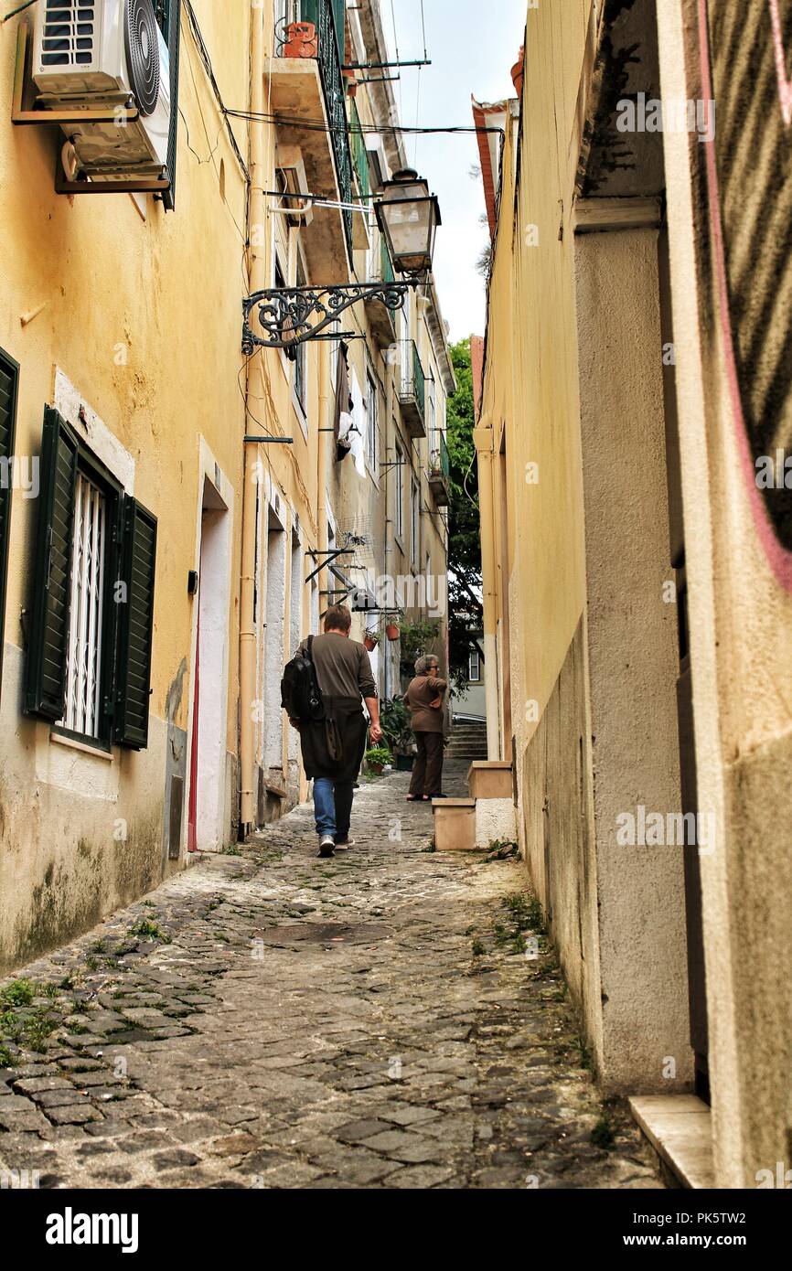 Lisbon, Portugal- June 10, 2018: Old colorful houses and narrow streets of Lisbon, Portugal in Spring. Majestic facades and old street lights. Stock Photo