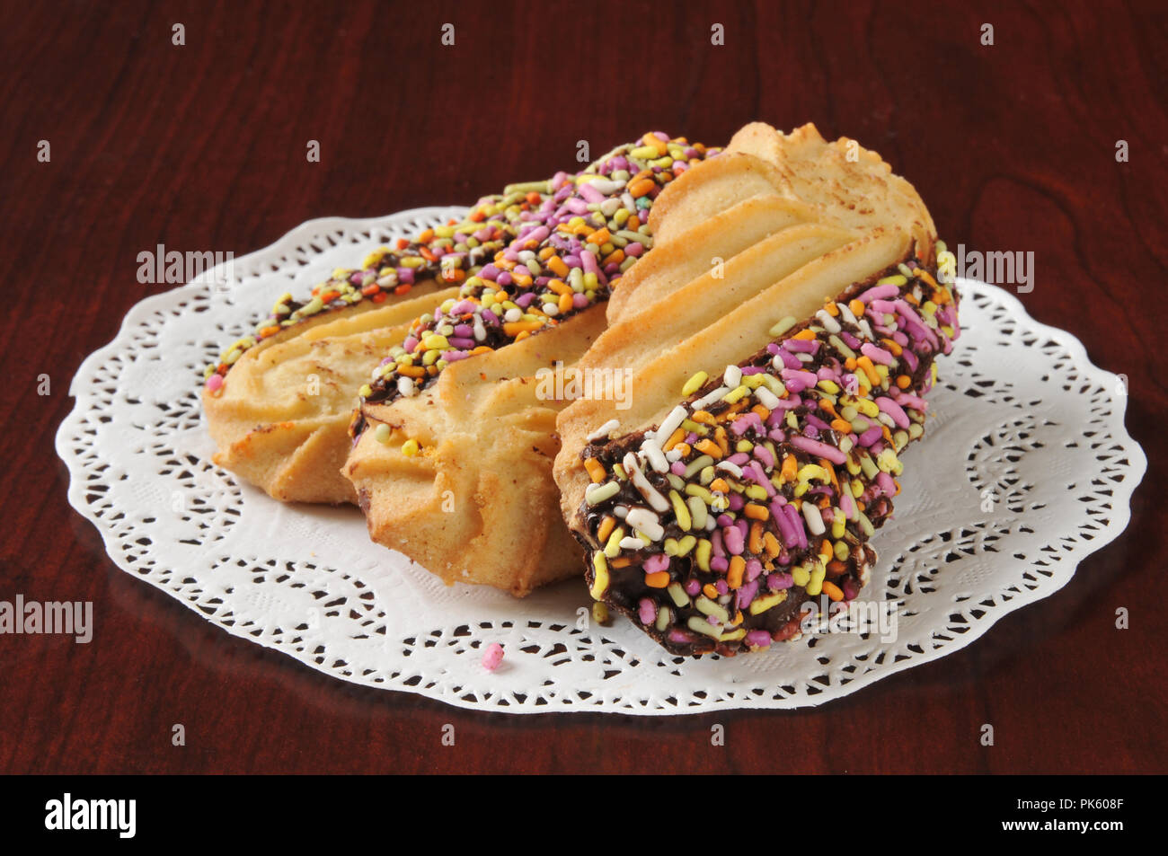 Gourmet shortbread cookies dipped in chocolate and covered with candy sprinkles Stock Photo