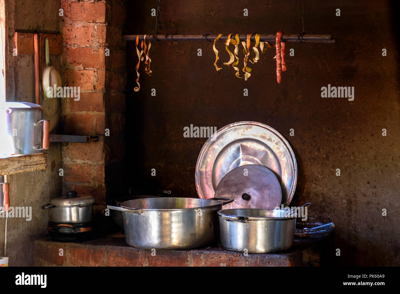 Old and ancient kitchen with wood stove and several pots used in