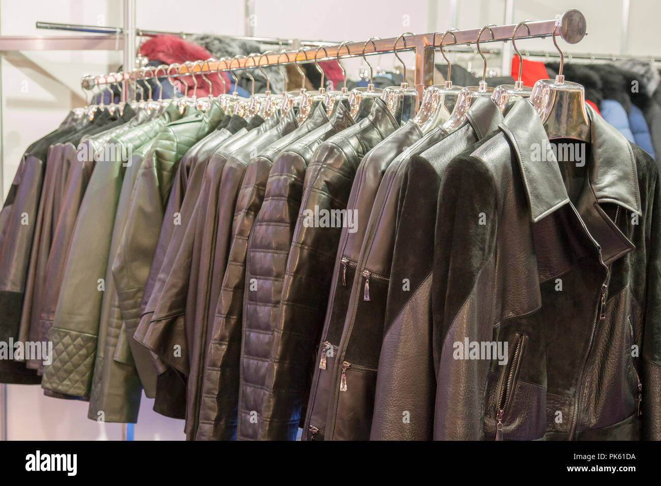 Leather jackets on the hangers at the store. Various leather jackets on