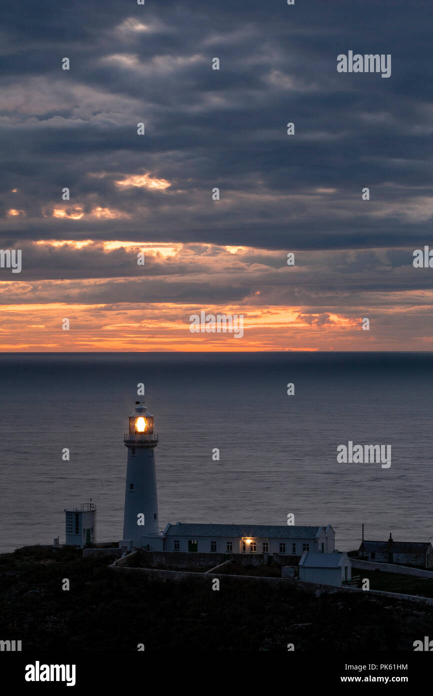 South Stack lighthouse at sunset on the coast of Anglesey, North Wales Stock Photo