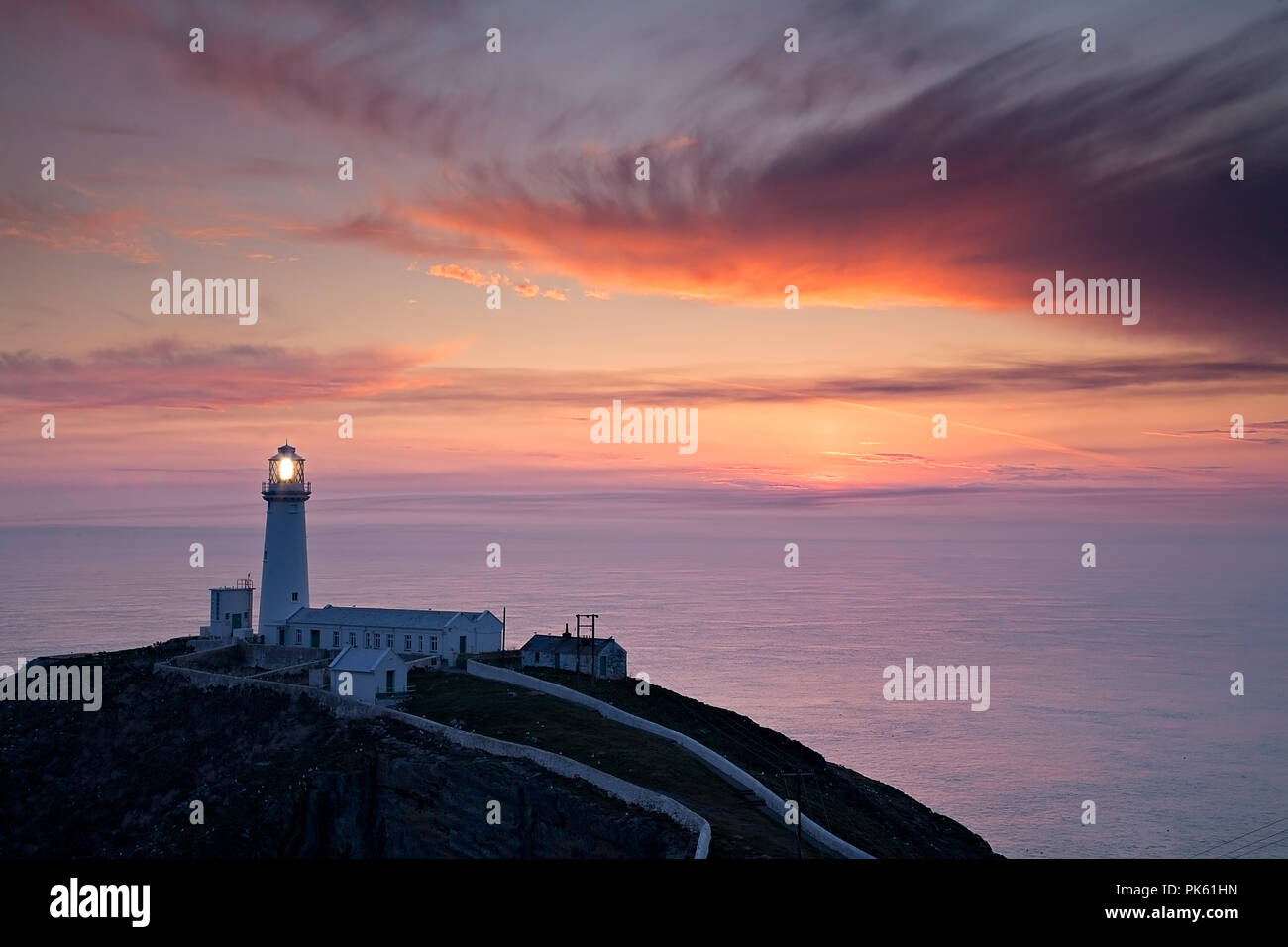 South Stack lighthouse at sunset on the coast of Anglesey, North Wales Stock Photo