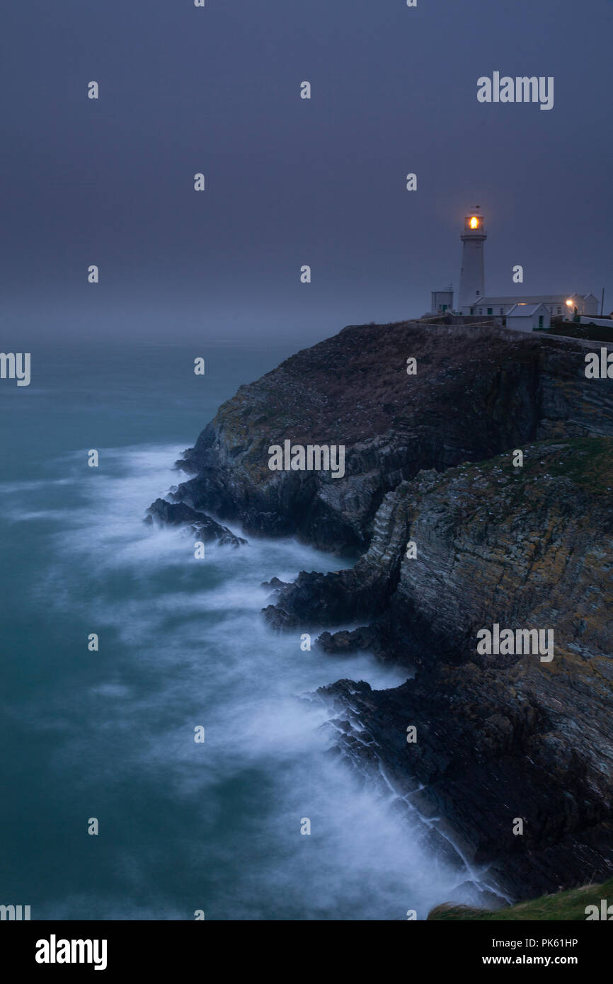 South Stack lighthouse in fog on the coast of Anglesey, North Wales Stock Photo