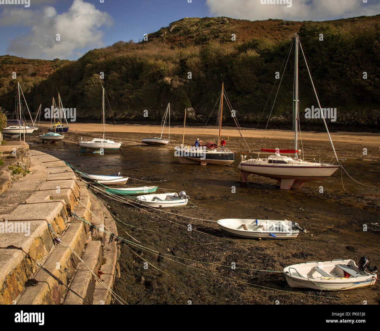 Small boats at low tide in Solva harbour, Pembrokeshire, Wales Stock Photo