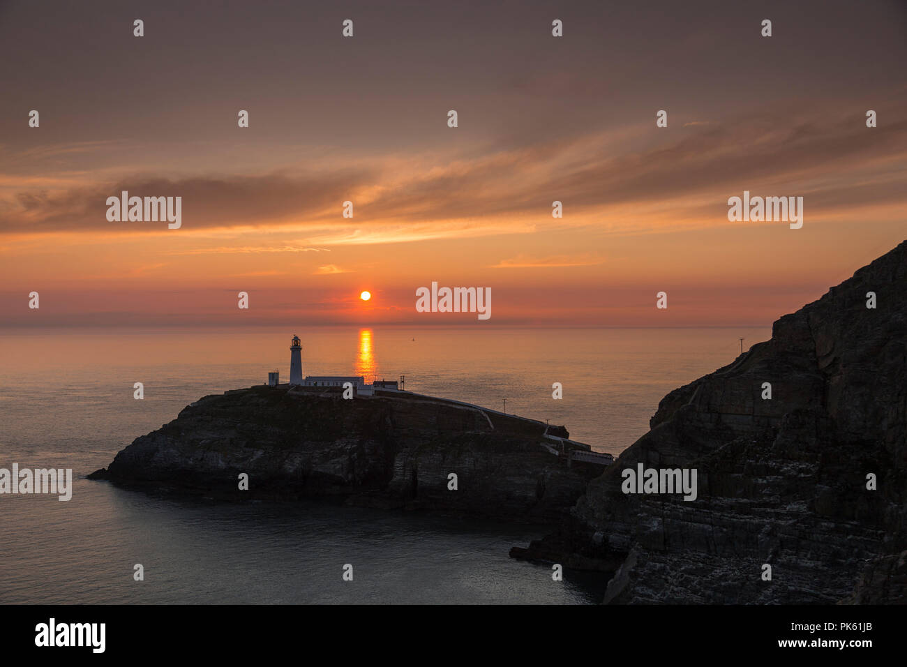 South Stack lighthouse at sunset on the coast of Anglesey, North Wales Stock Photo