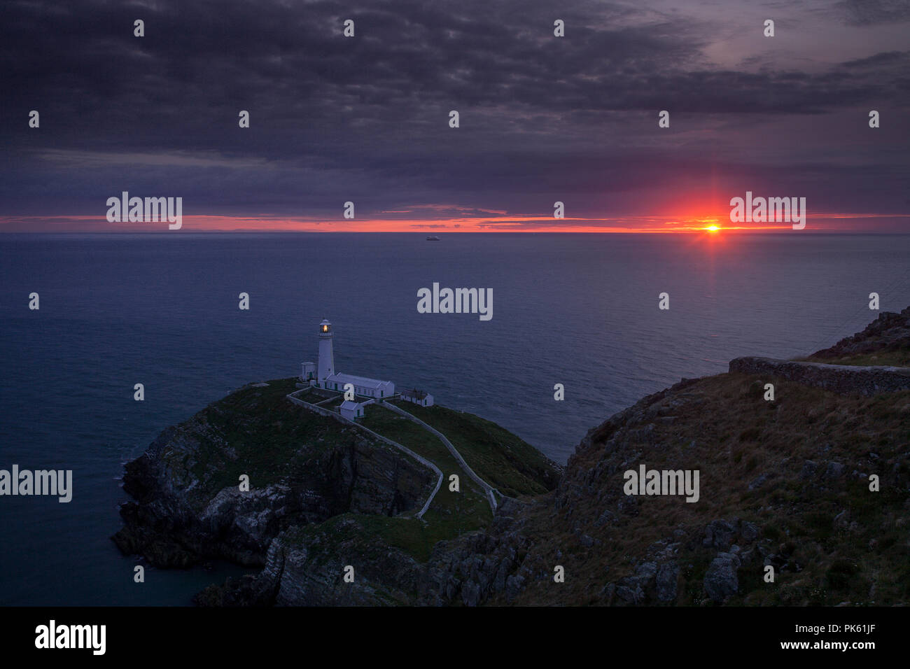 South Stack lighthouse at sunset on the coast of Anglesey, North Wales Stock Photo
