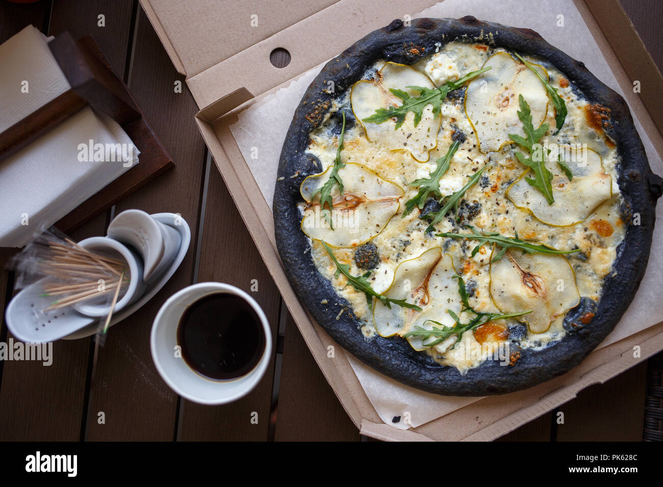 Black pizza four cheese with coffee top view image Stock Photo